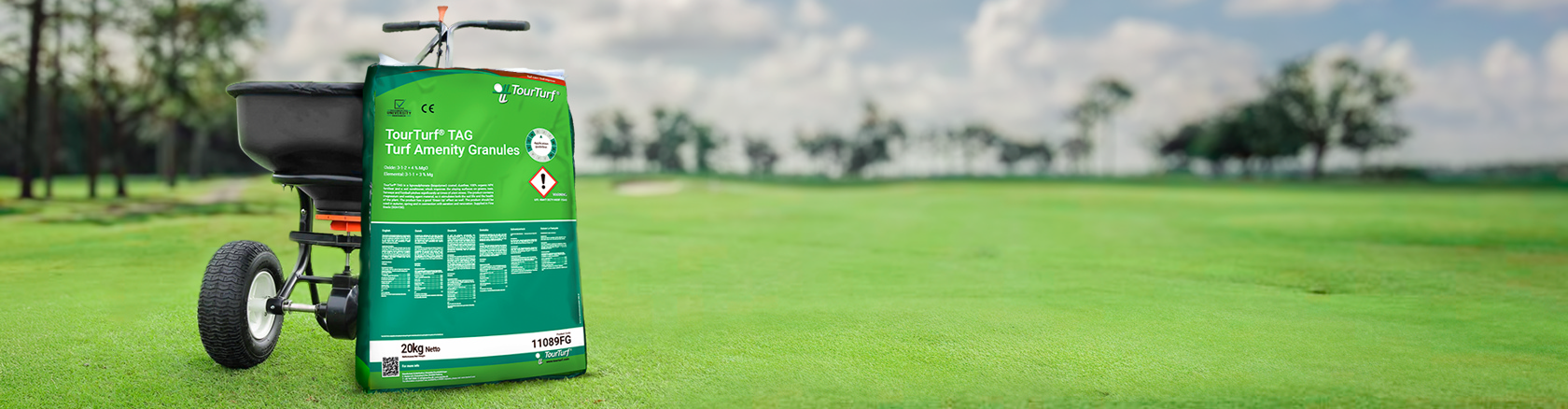 KSAB spreader with a bag of TourTurf TAG